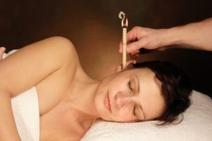 woman with ear candle therapy